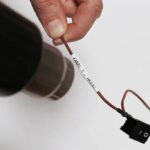 Brother HSE251E Bel/črn trak 21mm termo skrčljiv